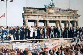  Berliners celebrate the reunification of their city on the Berlin Wall