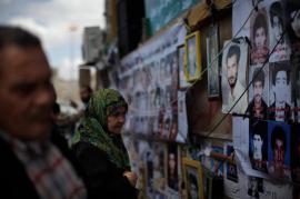 In Benghazi, a woman looked at photos of those killed under the current government.